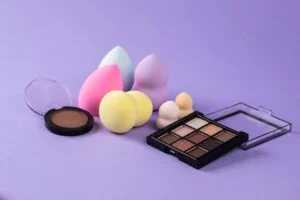 makeup products on purple surface